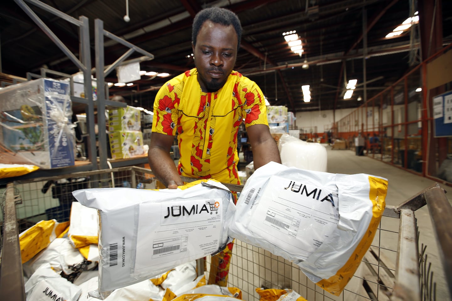 A worker sorts packages ready for dispatch inside a Jumia distribution warehouse in Lagos, Nigeria